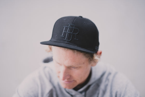 Snapback Flat Peak Cap Black - REEL BRAND